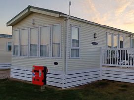 A caravan with windows and balcony at Park Lane View in Lossiemouth