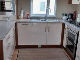 A kitchen with a sink and stove at B2 in Lossiemouth