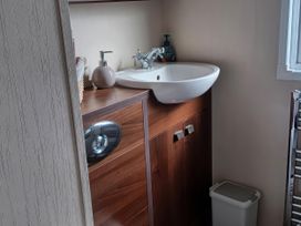 A bathroom with a sink and storage cabinet at B2 in Lossiemouth