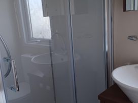 A bathroom with a shower toilet and sink at B2 in Lossiemouth