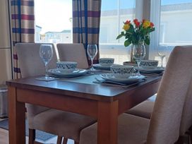 A dining room with a table set for a meal at B2 in Lossiemouth