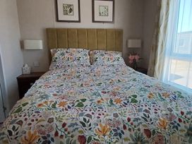 A bedroom with a bed and nightstand at B2 in Lossiemouth