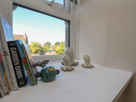 A windowsill with books and decorative items at Little Holm Garth in 