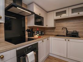A kitchen with cabinets and appliances at Little Holm Garth
