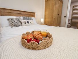 A bedroom with a bed and breakfast items on a tray at Little Holm Garth