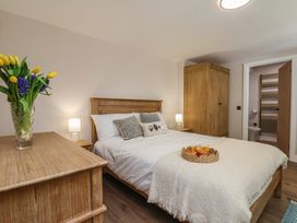 A bedroom with a bed and a wardrobe at Little Holm Garth