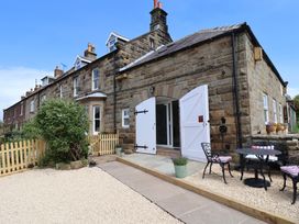 An outdoor area with seating and a garden at Little Holm Garth in Whitby