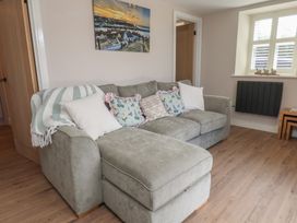 A living room with a sofa and wall art at Little Holm Garth in Whitby