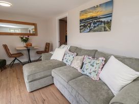 A living room with a sofa, table, and chairs at Little Holm Garth in Whitby