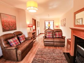 A living room with a sofa and coffee table at Derwent Cottage in Cockermouth