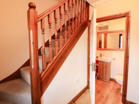 A hallway with a staircase and a bathroom at Derwent Cottage in Cockermouth