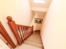 A staircase with a handrail and skylight at Derwent Cottage in Cockermouth