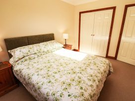 A bedroom with a bed and nightstand at Derwent Cottage in Cockermouth