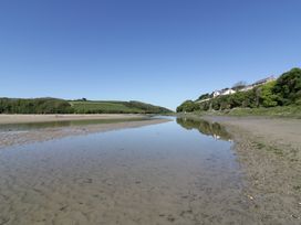 A view of a river with sand and trees at Shamrocks Cove Caravan
