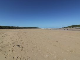 A beach with sand and water at Shamrocks Cove Caravan