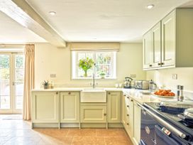 A kitchen with a sink and cabinets at Gitcombe Coach House in Totnes
