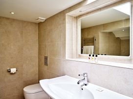 A bathroom with a sink and toilet at Gitcombe Coach House in Totnes