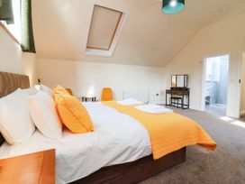 A bedroom with a double bed and a mirror at The Station House Blackmoor Gate near Parracombe