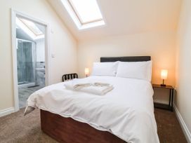 A bedroom with a bed and bathroom access at The Station House Blackmoor Gate near Parracombe