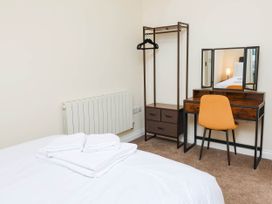 A bedroom with a bed and a vanity table at The Station House in Blackmoor Gate near Parracombe
