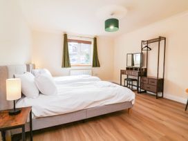 A bedroom with two beds and a dressing table at The Station House near Blackmoor Gate