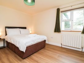A bedroom with a bed and nightstand at The Station House near Blackmoor Gate
