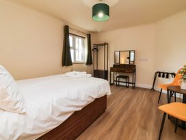 A bedroom with bed and dressing table at The Station House near Blackmoor Gate