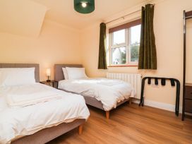 A bedroom with two beds and a window at The Station House Blackmoor Gate near Parracombe