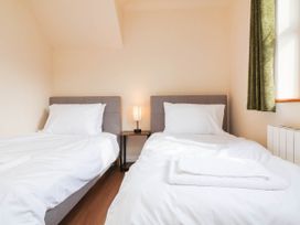 A bedroom with two beds and a lamp at The Station House in Blackmoor Gate near Parracombe