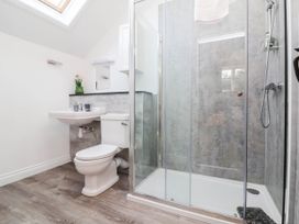A bathroom with a shower, sink and toilet at The Station House near Blackmoor Gate