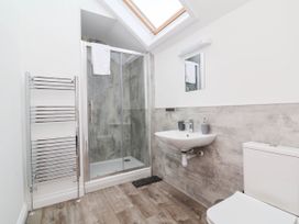 A bathroom with a shower and sink at The Station House Blackmoor Gate near Parracombe