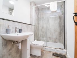 A bathroom with a shower, sink, and toilet at The Station House in Blackmoor Gate near Parracombe