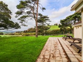 An outdoor area with trees and grass at The Station House Blackmoor Gate near Parracombe