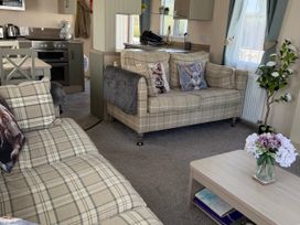 A living room with a couch and coffee table at Hoburne Blue Anchor - Holiday Accommodation 307 Minehead