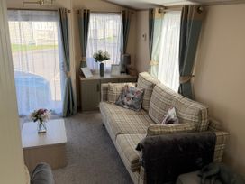A living room with a sofa and coffee table at Hoburne Blue Anchor - Holiday Accommodation 307 Minehead