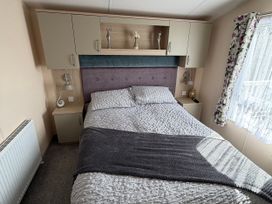 A bedroom with a double bed and cabinets at Hoburne Blue Anchor - Holiday Accommodation 307, Minehead