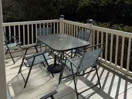 An outdoor seating area with a table and chairs at Hoburne Blue Anchor - Holiday Accommodation 307, Minehead