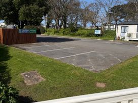 An outdoor area with parking spaces and waste disposal bins at Hoburne Blue Anchor - Holiday Accommodation 307 Minehead