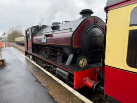 A steam locomotive at a railway station at Hoburne Blue Anchor - Holiday Accommodation 307 Minehead