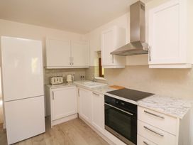 A kitchen with a refrigerator, stove, and sink at The Mews @ Suskar, Laragh, County Wicklow