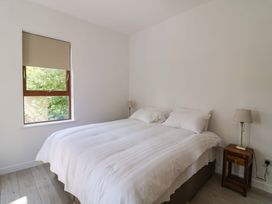 A bedroom with a bed and bedside tables at The Mews @ Suskar, Laragh, County Wicklow