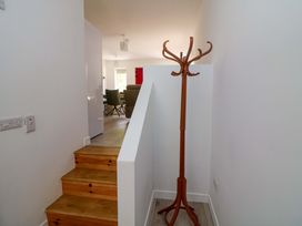 A hallway with a coat stand and stairs at The Mews @ Suskar, Laragh, County Wicklow