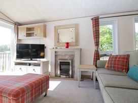 A living room with a television and a fireplace at Borwick Heights 17 Carnforth