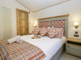 A bedroom with a bed and pillows at Borwick Heights 17 in Carnforth