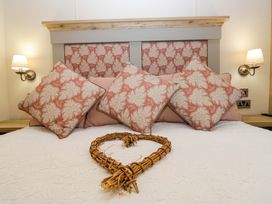 A bedroom with pillows on a bed at Borwick Heights 17 in Carnforth