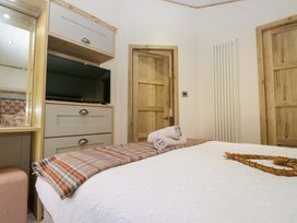 A bedroom with a bed and television at Borwick Heights 17 Carnforth