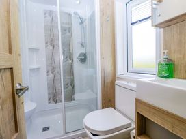 A bathroom with shower, toilet, and sink at Borwick Heights 17 Carnforth