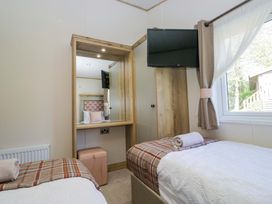 A bedroom with two beds and a dressing table at Borwick Heights 17 Carnforth