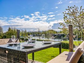 A table set with glasses and plates overlooking a lake at Borwick Heights 17 Carnforth
