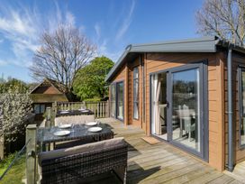 An outdoor area with a table and chairs at Borwick Heights 17 in Carnforth